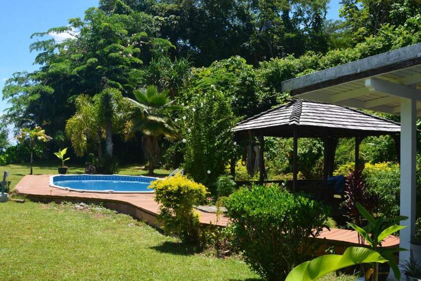 Tropical garden, pool and covered pavilion at Villa MERAHI